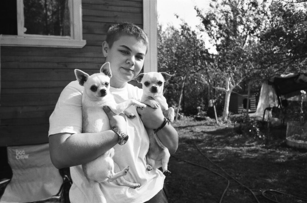 girl holding two chihuahuas