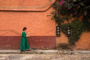 Latin woman walking her chihuahua dogs in San Miguel de Allende, Mexico